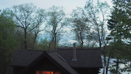 Aerial View of a Cozy Log Cabin by Lake