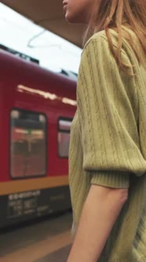 Young woman boarding a train at a railway station