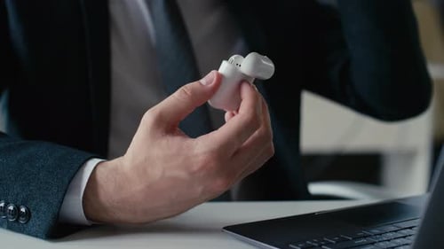 Taking Earbuds from Earphone Case in Office