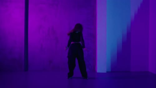 FullLength Portrait Of Pretty Girl Dancing Modern Choreography In Studio With Neon Lights