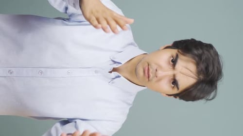 Vertical video of Man getting angry at camera.