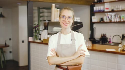 Experience the Inviting Atmosphere of a Friendly Barista Working in a Modern Coffee Shop Setting