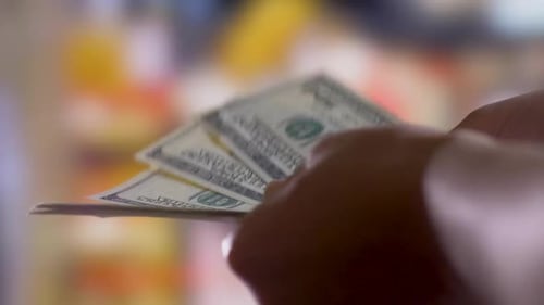 Hands Fanning Out One Hundred Dollar Bills