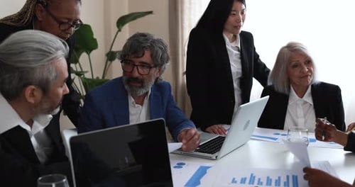 Multiracial business team collaborates in a modern bank office setting in the USA