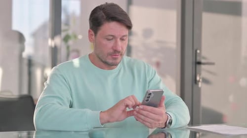 Man Using Smartphone Indoors