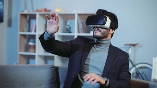 Man Experiences Virtual Reality While Relaxing at Home