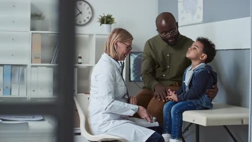 Doctor Examines Little Boy with Father Present