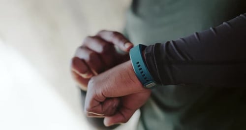 Person Using Digital Smart Watch on Arm