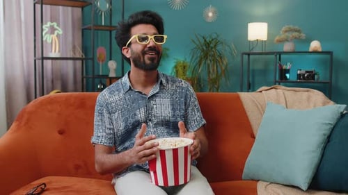 Man Watching Movie with Popcorn Wearing 3D Glasses