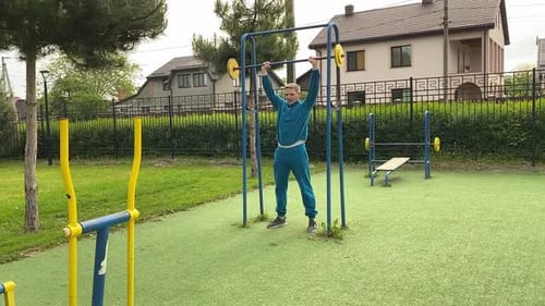 A male athlete works out at the outdoor gym