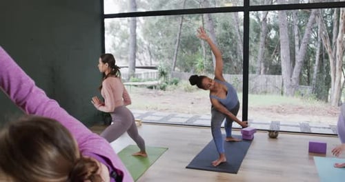 Women Practicing Yoga in Bright Studio