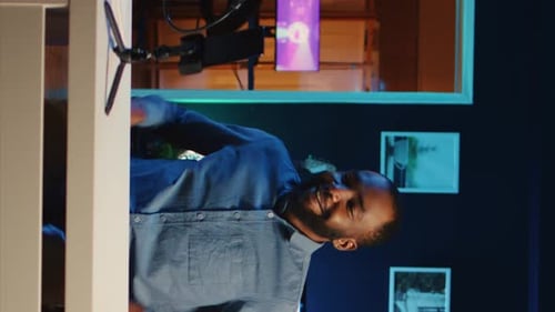Man In Blue Shirt Speaking To Camera