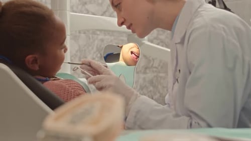 Little Girl Visiting Dentist at Clinic