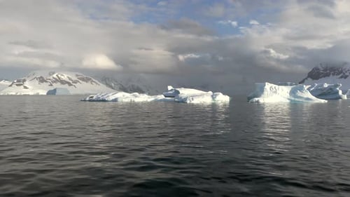Frozen Arctic Ocean with Floating Icebergs Aerial Shot
