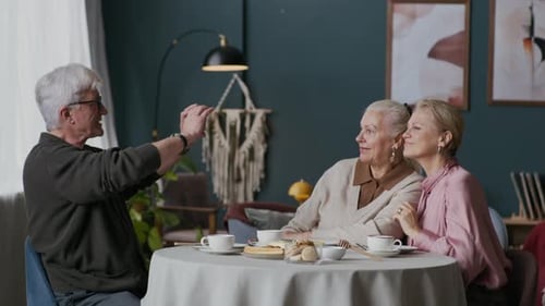 Older friends taking a photo with a mobile phone