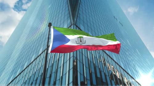 Equatorial Guinea Flag Waving in Front of Modern Corporate Building