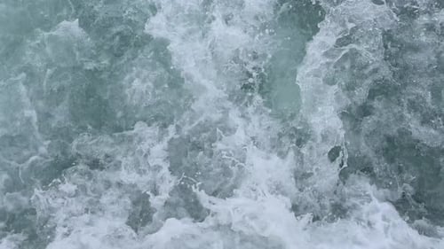 Slow Motion Top View of Powerful Ocean Waves and Splashing White Foam
