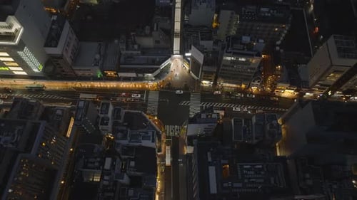 Vue à angle élevé des rues et des carrefours dans un arrondissement urbain la nuit, piétons empruntant les passages pour piétons