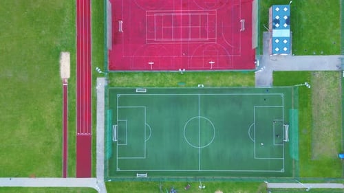 Recreational green grass active sports hockey and football fields overhead top down view. Competitio