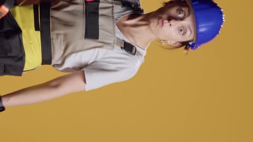 Vertical Video Portrait of Empowered Female Builder Acting Dangerous with Hammer