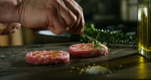Preparing Raw Burger Patties with Rosemary