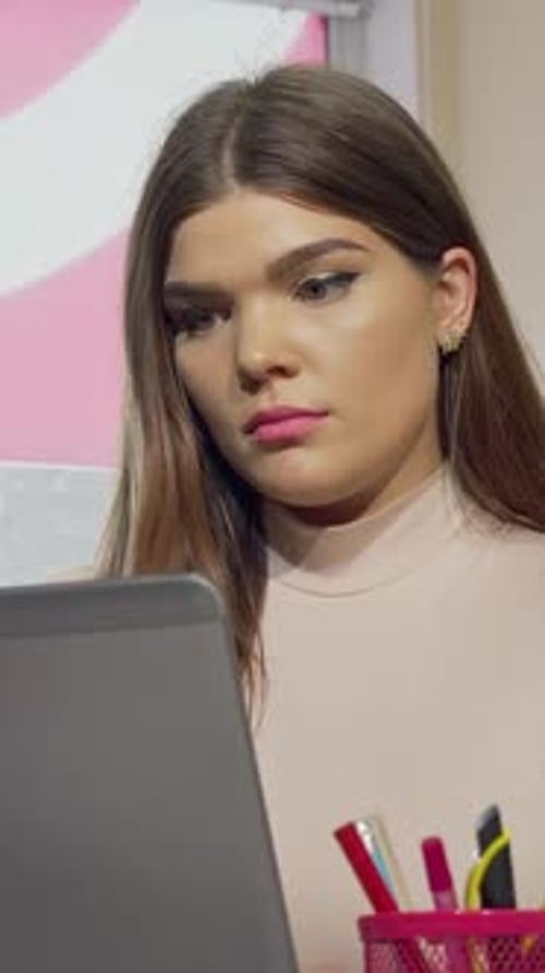Exhausted Female Student Stressed While Working on a Laptop