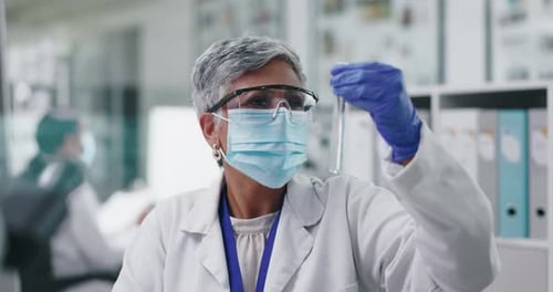 Woman Scientist Examining Test Tube in Laboratory