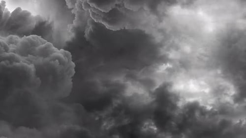 view of thick clouds moving in the dark sky.