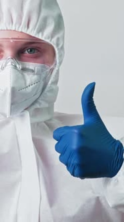 Medical Professional in Protective Suit Gives Thumbs Up