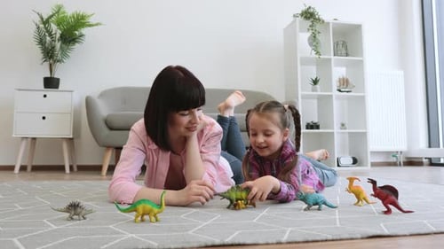 Woman and Child Play with Dinosaur Toys at Home