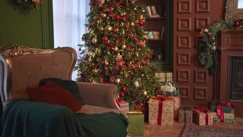 Christmas tree with presents and cozy armchair indoors