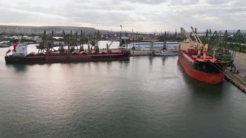 Industrial Port with Cargo Ships and Cranes