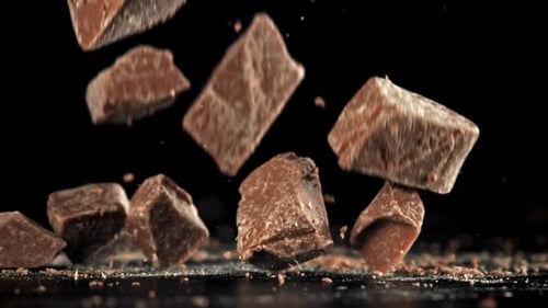 Pieces of Chocolate Fall on the Table Filmed on a Highspeed Camera at 1000 Fps