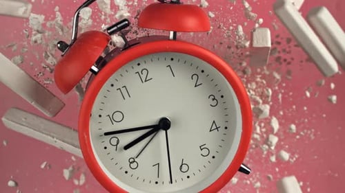 Alarm Clock and School Crayons Fly Up on a Black Background Filmed on a Highspeed Camera at 1000 Fps