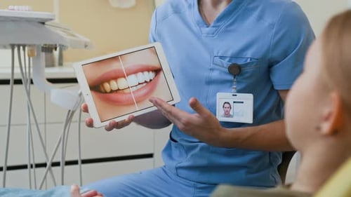 Male Dentist Explaining Teeth Whitening