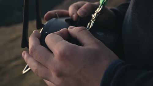 Close Up Of Hands Operating Drone Joystick Outdoor.