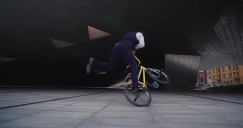 Man Does Bicycle Trick in an Urban Setting