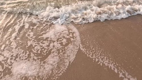 Wave splashing in sunrise or sunset on a tropical beach.