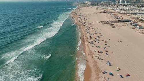 A Breathtaking and Stunning Aerial View of a Bustling Beach Scene Filled with Waves and People