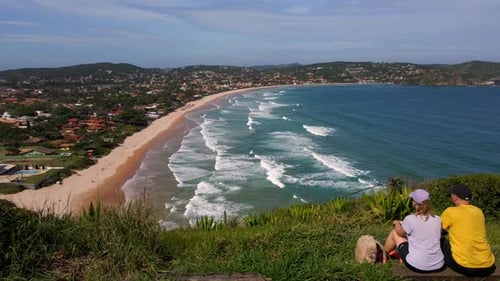 Couple of Hikers Enjoying the Sea View From the Cliff