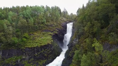 Nature's Majesty: Discover the Beauty of a Picturesque Waterfall in the Mountains 4K