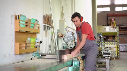 Carpenter Trimming Wooden Plank in Professional Workshop