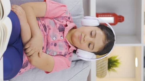 Girl Relaxing with Headphones on Couch