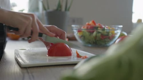 Close Up of Tomato Being Cut on Board