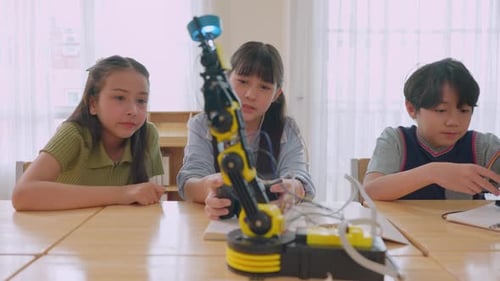 Group of students learning in a robotics class at elementary school.
