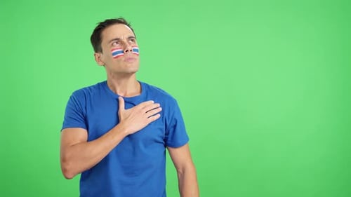Man Listening to the Thailand National Anthem with Solemnity
