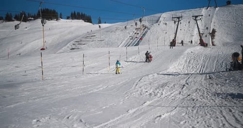 People Skiing In Alps Mountains On Sunny Day - Skier Riding Down On Winter Time And Taking Ski Li...