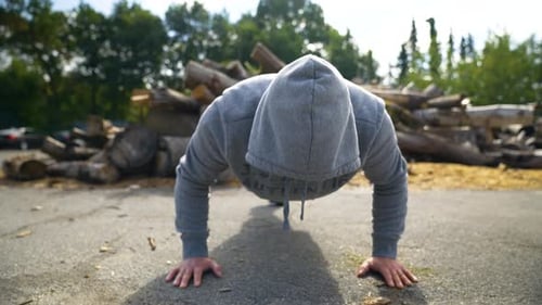Man Doing Push-Ups in Urban Outdoor Setting