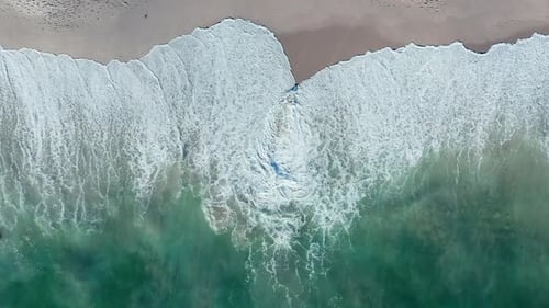 White Frothy Waves Rolling Onto Sandy Shore Of Blouberg Sea In Cape Town, South Africa. Aerial Topdo