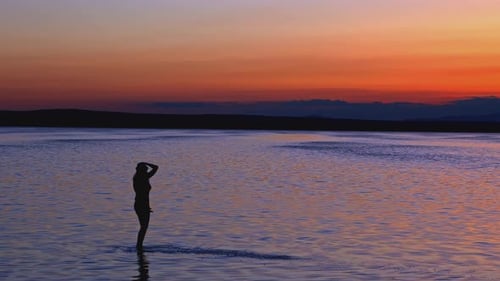 Silhouette Woman Dancing in Sunset Waters